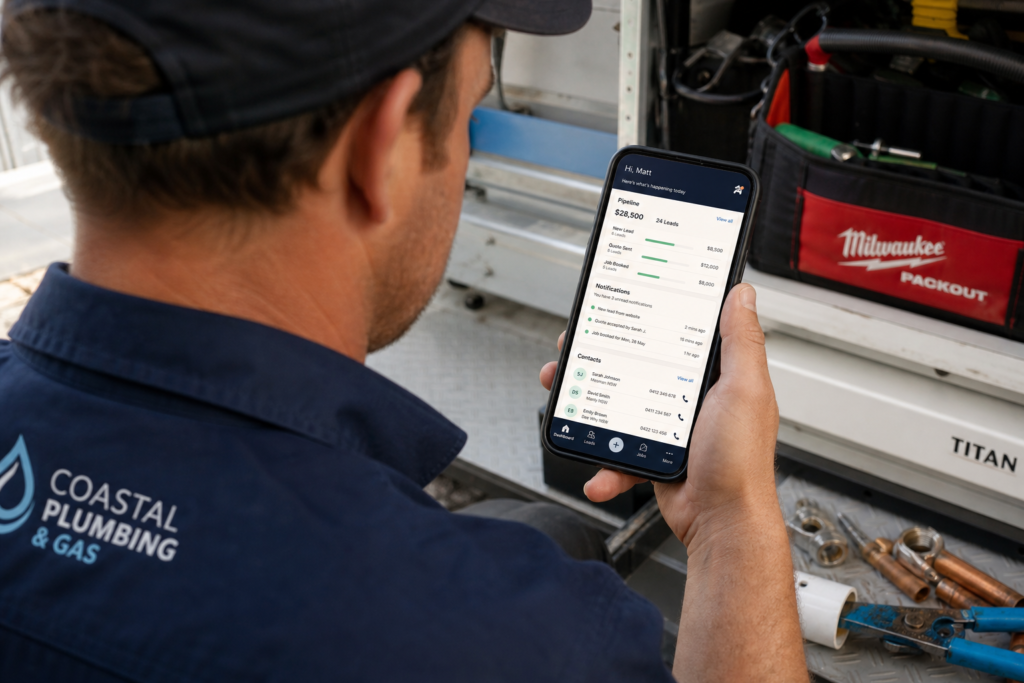 Australian tradesperson checking CRM dashboard on smartphone showing lead pipeline and customer contacts